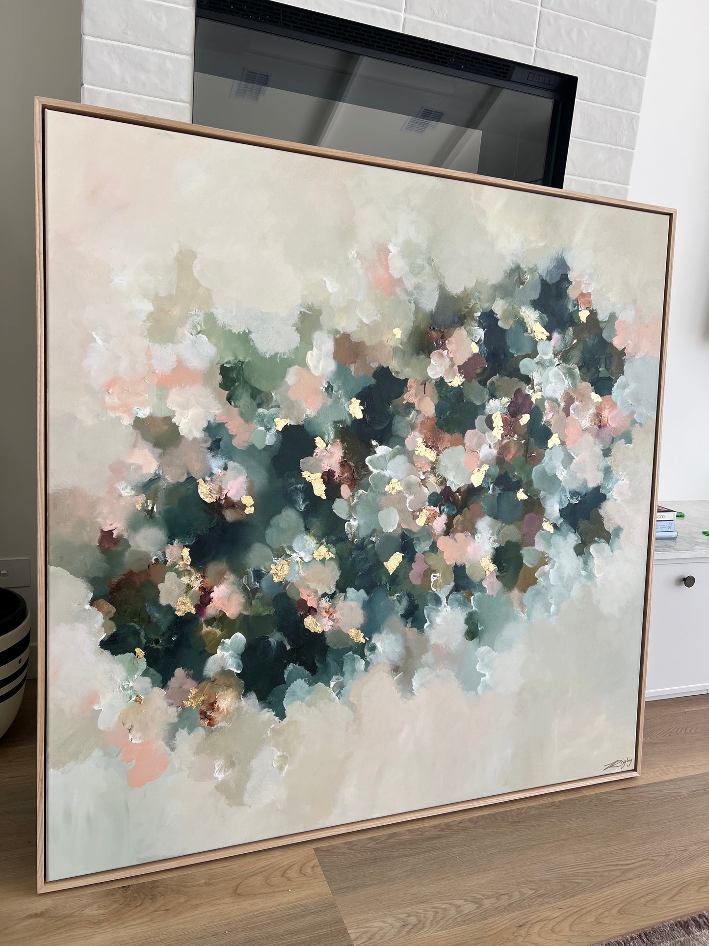 Framed abstract painting on a wall with a neutral background