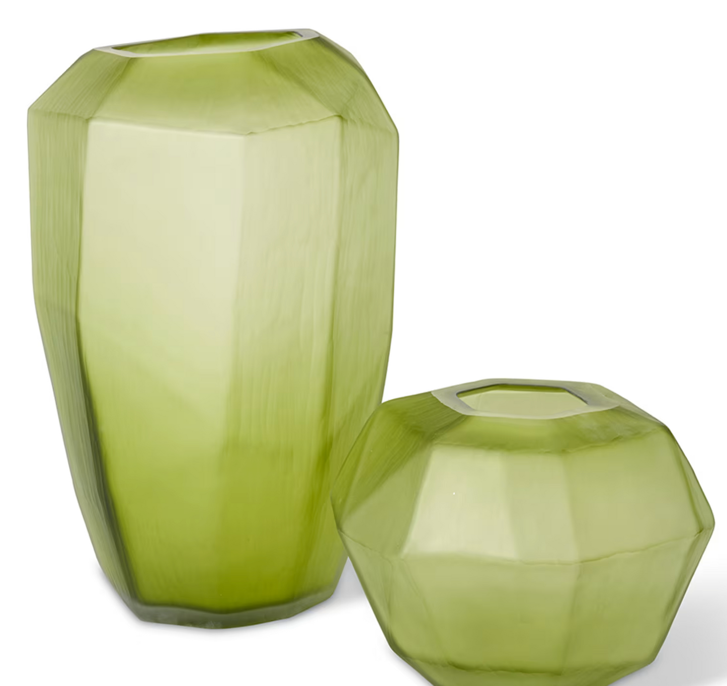 Two green faceted vases on a white background