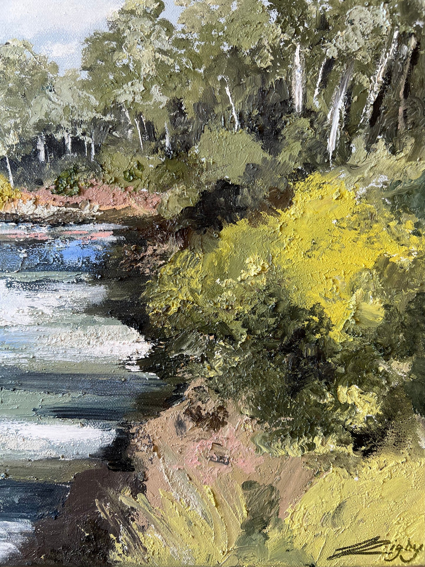 Warrandyte on the River, An impressionistic landscape painting depicting a river or shoreline with dense green and yellow foliage, dark tree trunks, and blue-gray water, with visible painterly brushstrokes throughout.