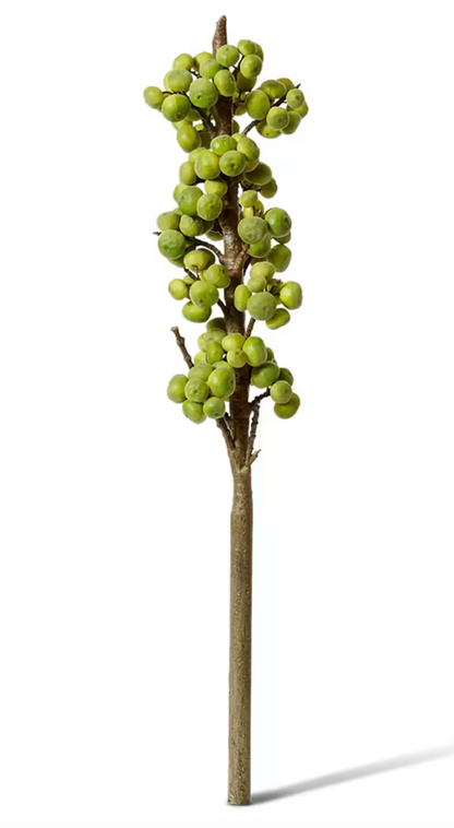 Artificial green tree branch with figs on a white background