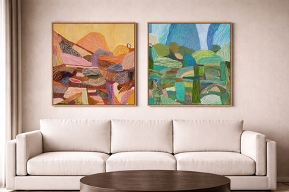 Two abstract paintings on a wall above a white sofa.