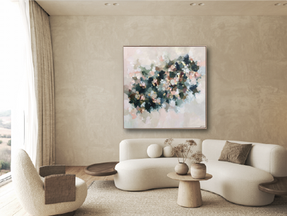 Modern living room with a white sofa, side chairs, and a abstract floral painting on the wall.