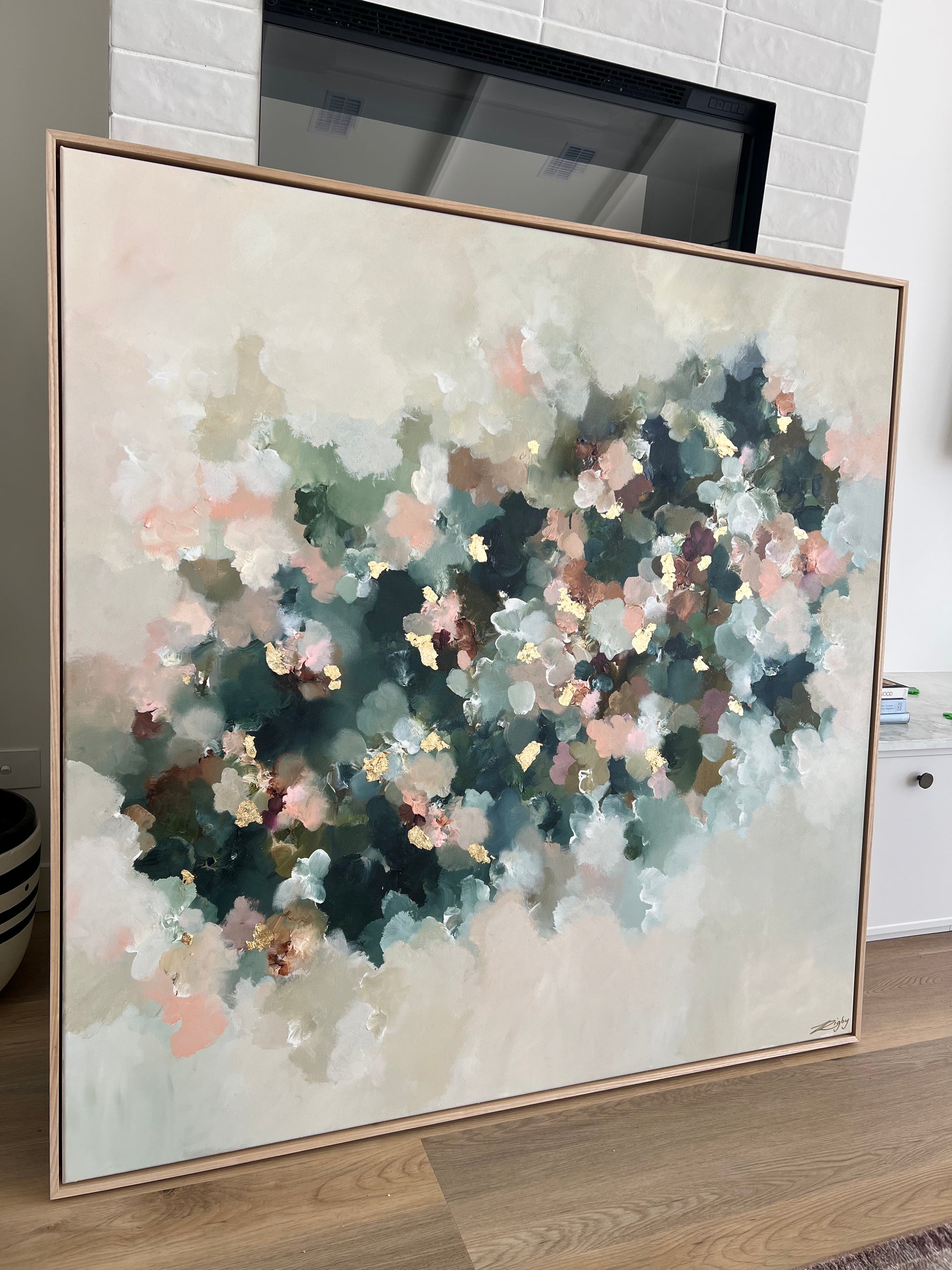 Framed abstract painting on a wall with a neutral background