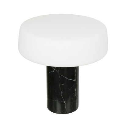 Table lamp with white shade and black marble base on a white background