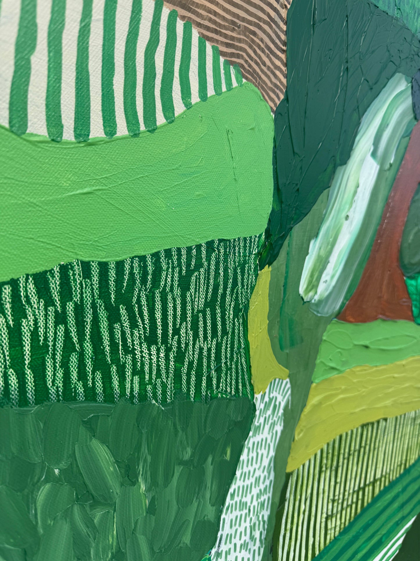 JWG Close-up of a textured green fabric with patterns and colors