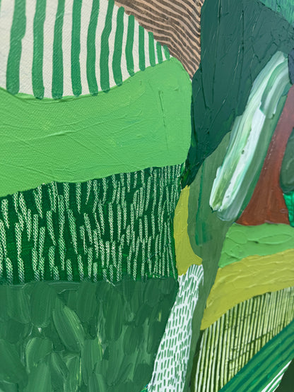 JWG Close-up of a textured green fabric with patterns and colors