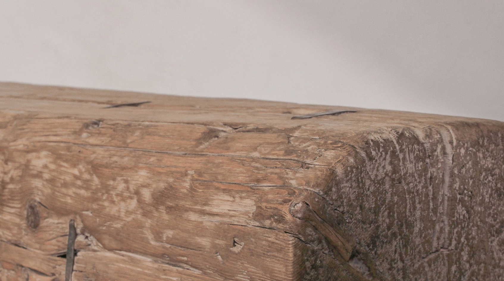 Close-up of a wooden surface with a natural, rustic texture.