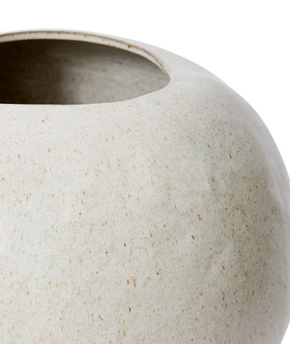 Close-up of a textured ceramic pot on a white background